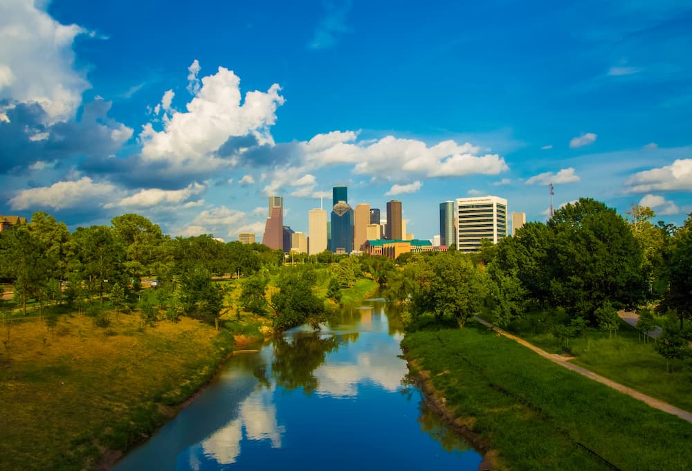 Downtown Houston skyline on a sunny day with a few fluffy clouds